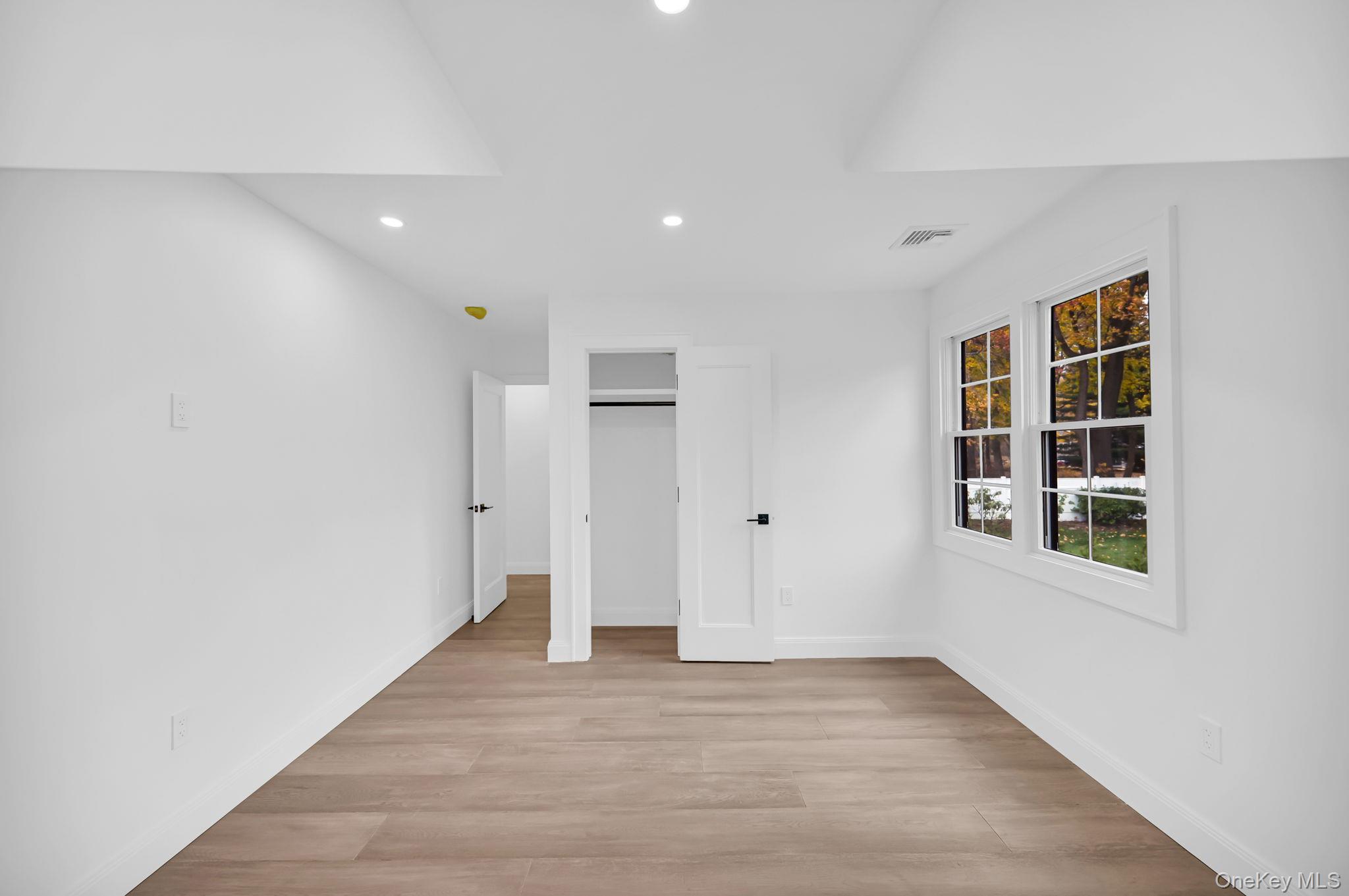 82 Seton Drive New Rochelle, NY 10804 - Photo 28 of 50 a view of an empty room with wooden floor and windows
