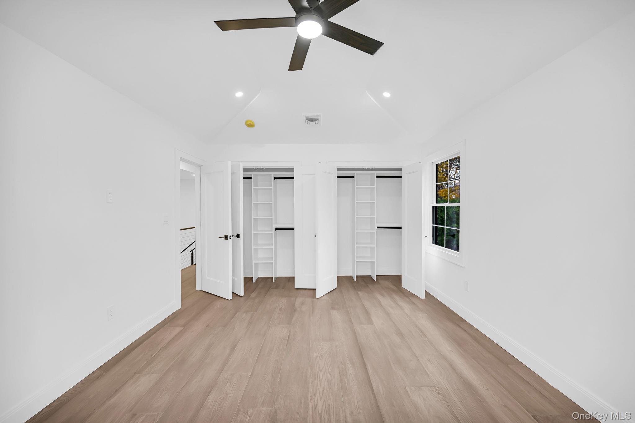 82 Seton Drive New Rochelle, NY 10804 - Photo 29 of 50 a view of empty room with wooden floor and fan