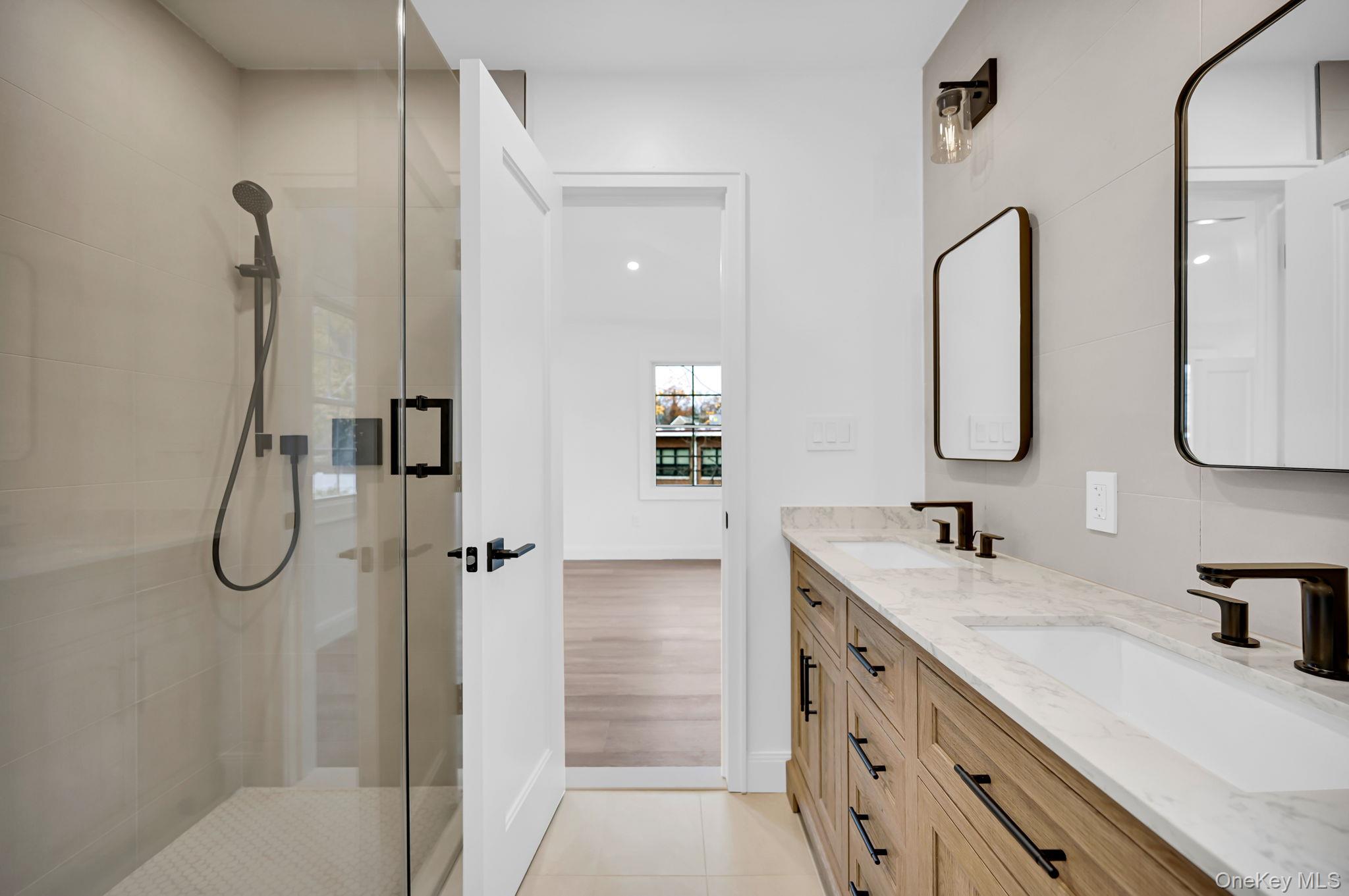 82 Seton Drive New Rochelle, NY 10804 - Photo 33 of 50 a bathroom with a double vanity sink double mirror and shower