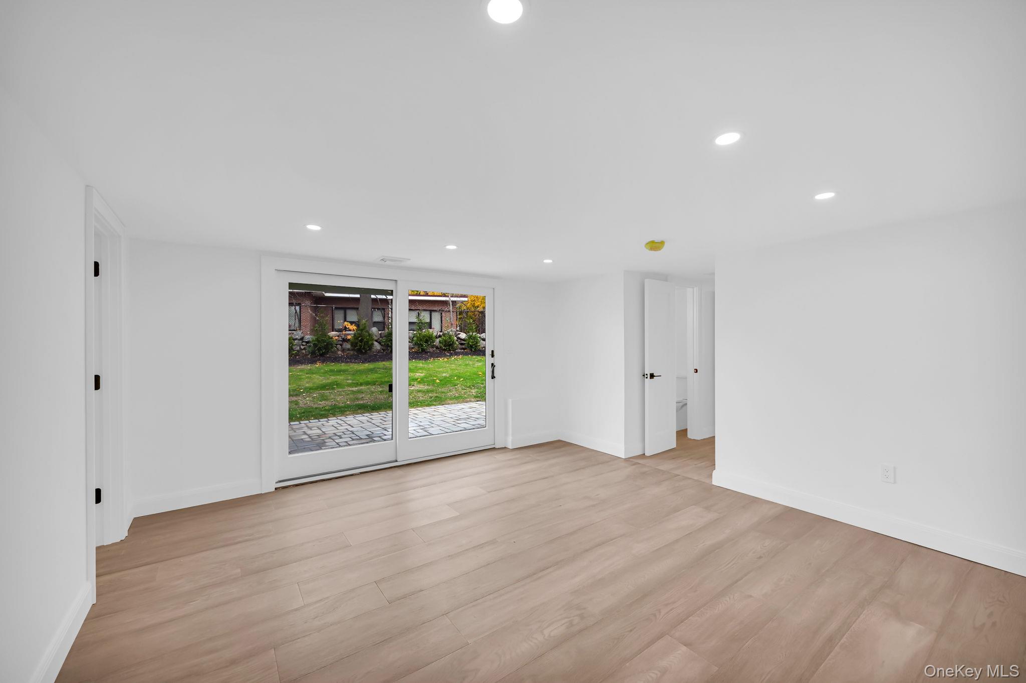 82 Seton Drive New Rochelle, NY 10804 - Photo 36 of 50 a view of an empty room with wooden floor and a window