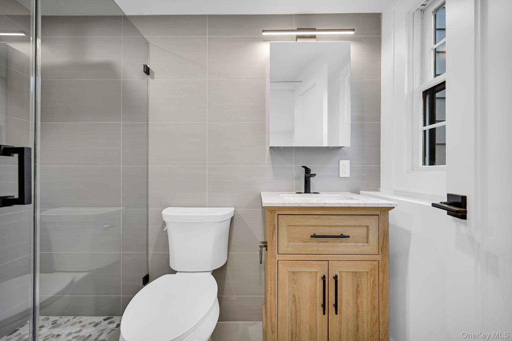 82 Seton Drive New Rochelle, NY 10804 - Photo 40 of 50 a bathroom with a sink a toilet and shower