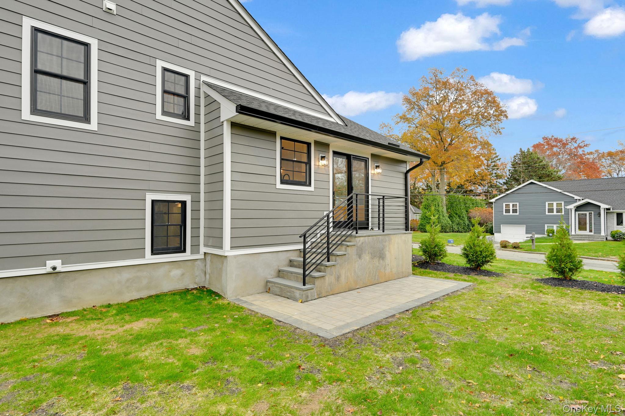 82 Seton Drive New Rochelle, NY 10804 - Photo 43 of 50 a front view of a house with a yard and garage