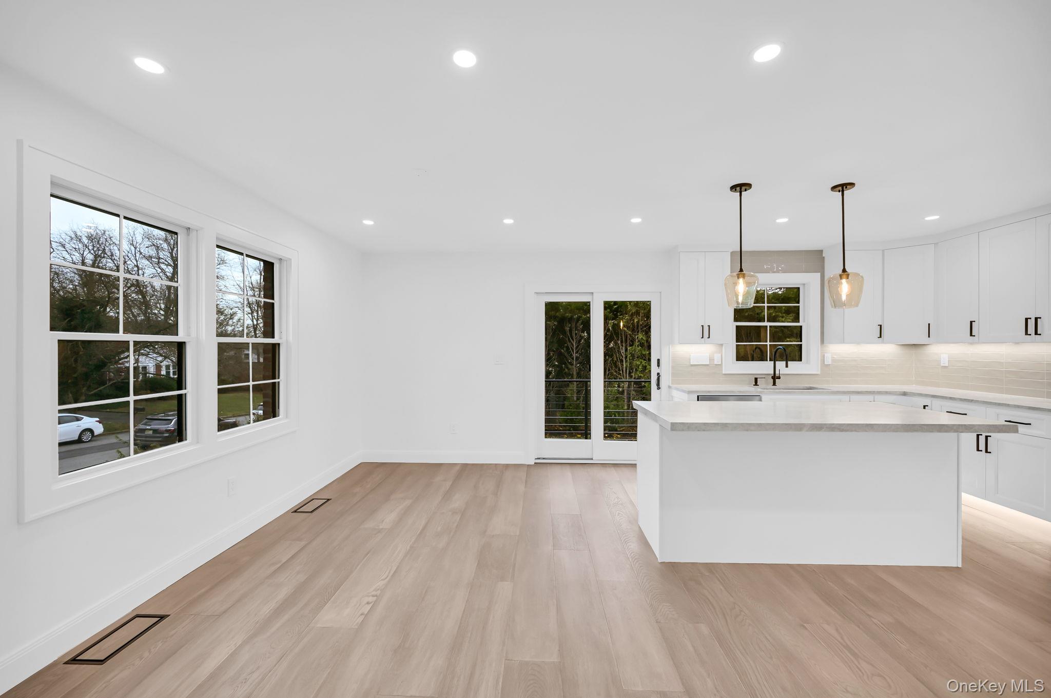82 Seton Drive New Rochelle, NY 10804 - Photo 8 of 50 a kitchen with stainless steel appliances granite countertop a stove top oven a sink dishwasher and a fireplace with wooden floor