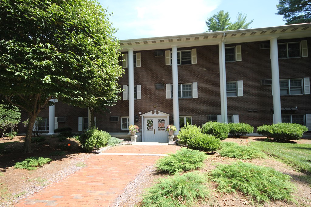 209 Great Road, Unit B5 Acton, MA 01720 - Photo 1 of 11 a front view of a house with a yard
