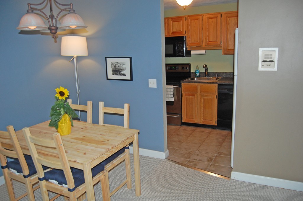 209 Great Road, Unit B5 Acton, MA 01720 - Photo 4 of 11 a view of a dining room with furniture and chandelier