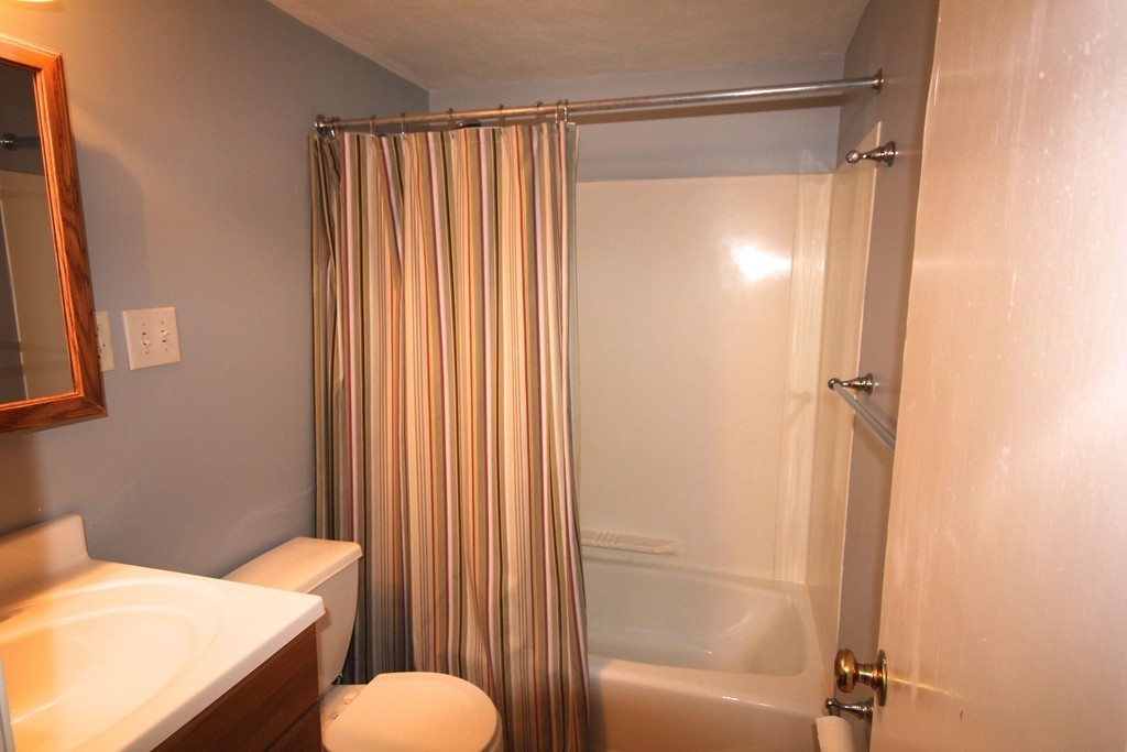 209 Great Road, Unit B5 Acton, MA 01720 - Photo 7 of 11 a bathroom with a shower curtain and a sink