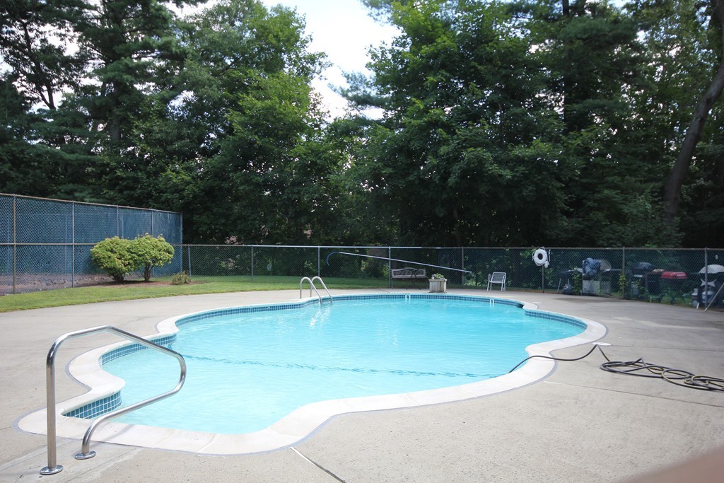 209 Great Road, Unit B5 Acton, MA 01720 - Photo 8 of 11 a view of a swimming pool with a lounge chair