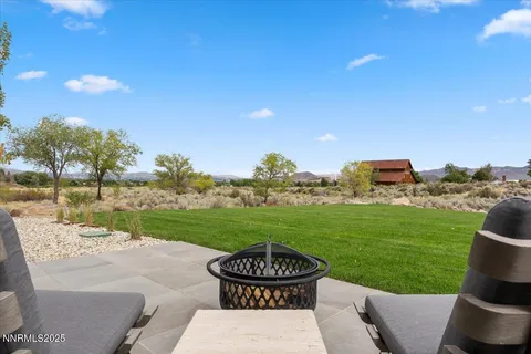 a kitchen with stainless steel appliances kitchen island granite countertop a table chairs sink and cabinets