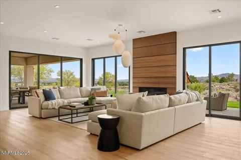 a living room with furniture and floor to ceiling windows