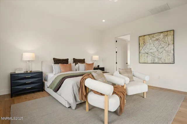 a spacious bedroom with a bed and a couch