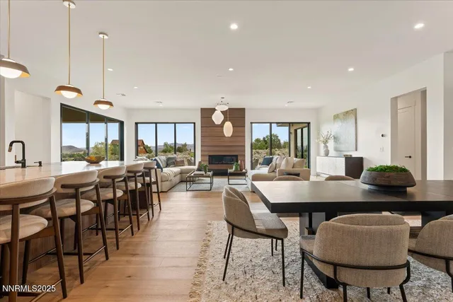 a view of a a dining room with furniture window and wooden floor