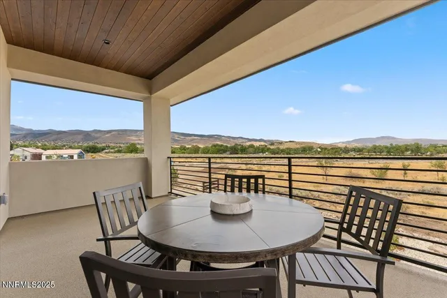 a view of an outdoor dining space with furniture and garden view
