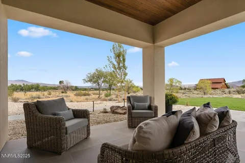a view of a terrace with couches and sky view
