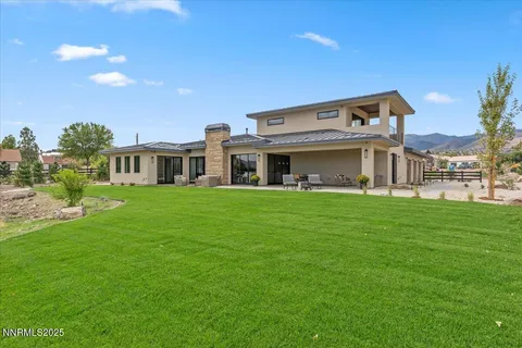 a view of a house with backyard porch and sitting area