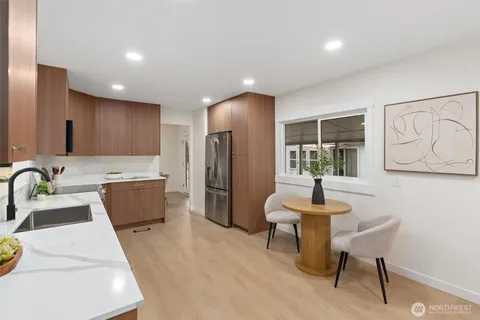 a kitchen with refrigerator and chairs