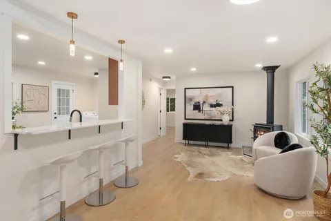 a large white kitchen with a large window
