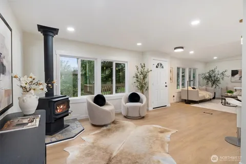 a living room with furniture and large windows