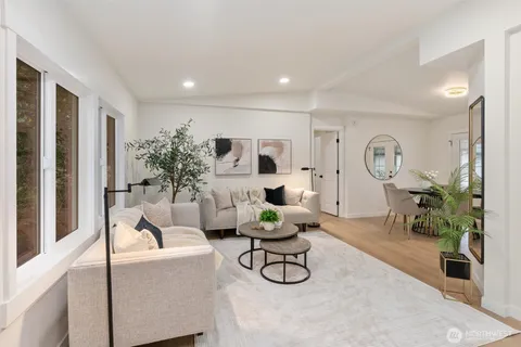a living room with furniture potted plant and a chandelier