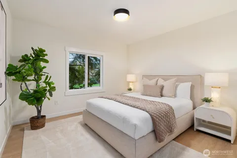 a bedroom with bed and a plant