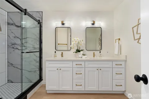a bathroom with a double vanity sink mirror and double
