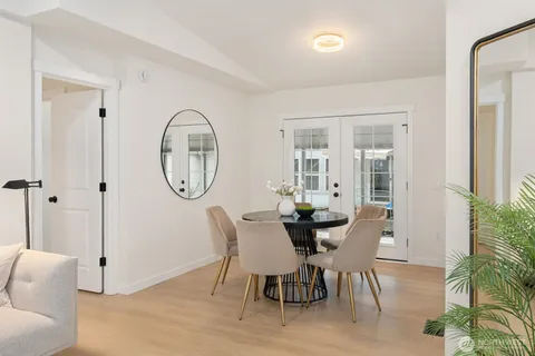 a view of a dining room with furniture and a potted plant