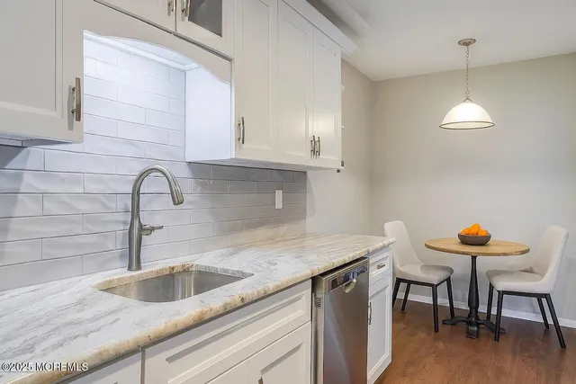 a kitchen with a sink cabinets and a table