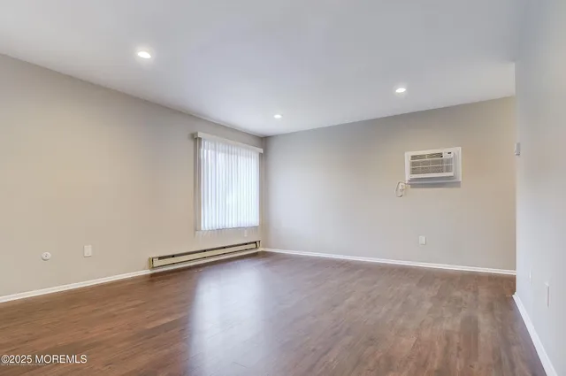 a view of wooden floor and windows in a room
