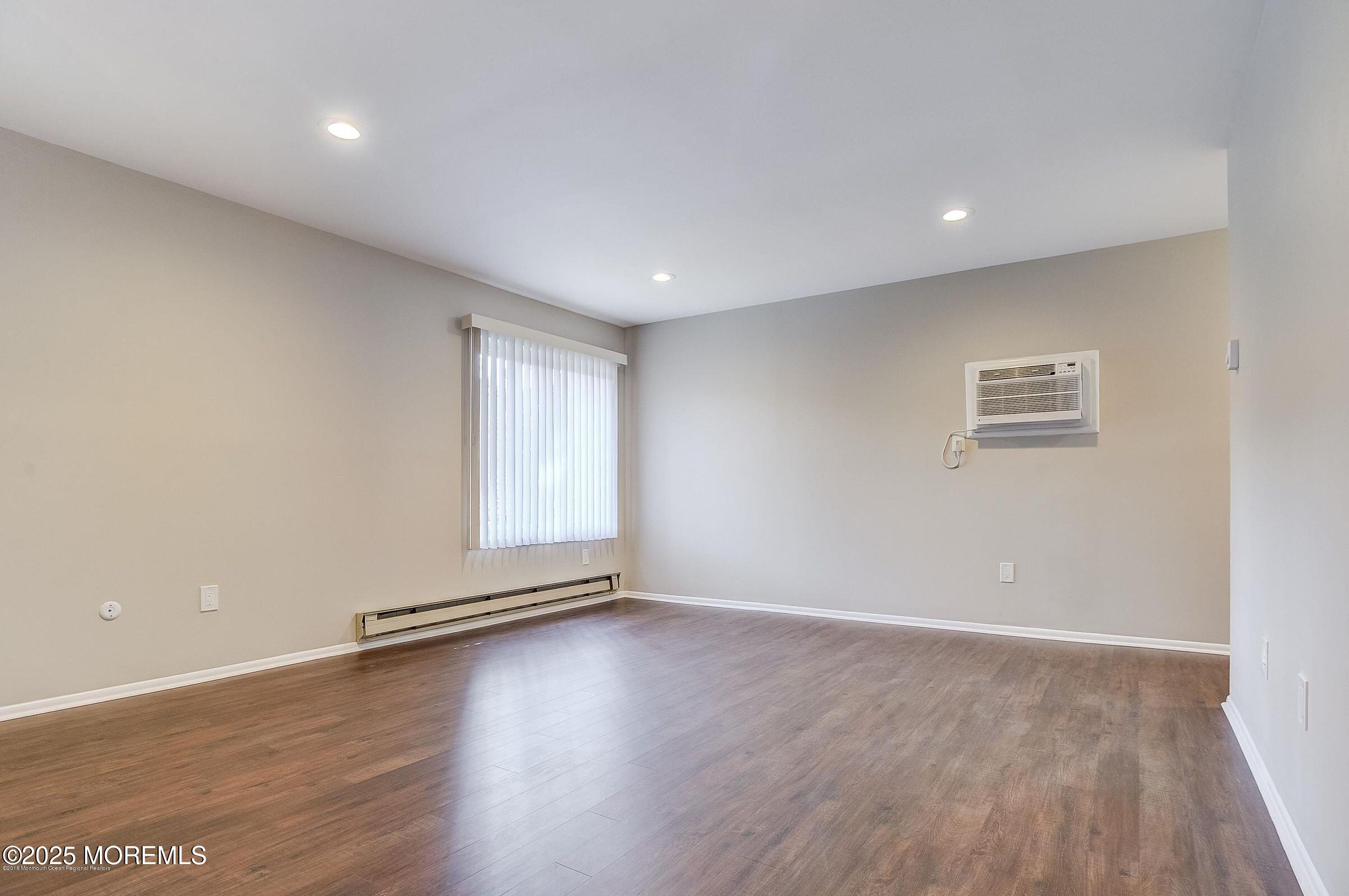 97 Arrowood Road, Unit K Manalapan, NJ 07726 - Photo 18 of 29 a view of wooden floor and windows in a room