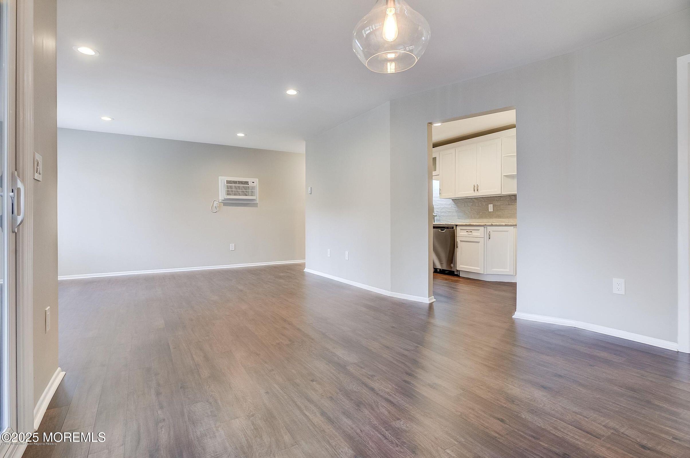 97 Arrowood Road, Unit K Manalapan, NJ 07726 - Photo 19 of 29 wooden floor in an empty room with a window