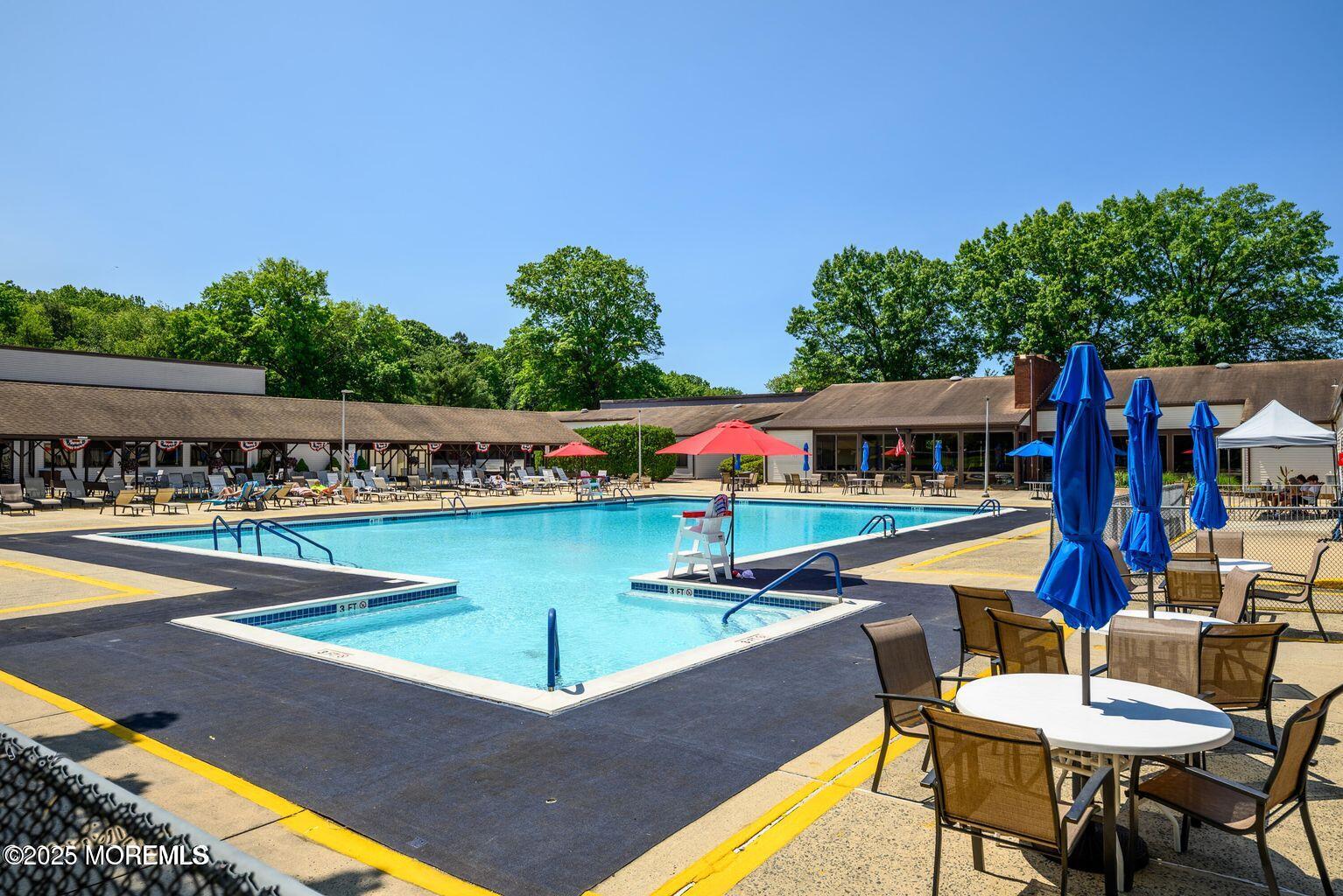 97 Arrowood Road, Unit K Manalapan, NJ 07726 - Photo 23 of 29 a view of an chairs and table in the terrace