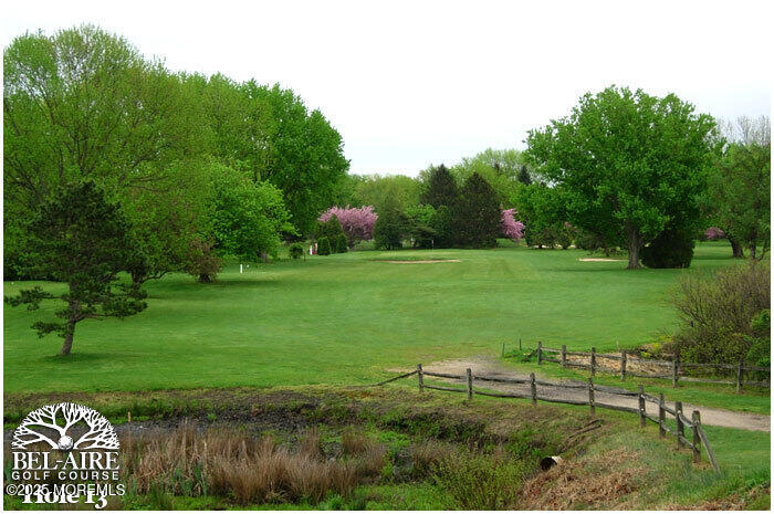 97 Arrowood Road, Unit K Manalapan, NJ 07726 - Photo 27 of 29 a view of a garden with a lake
