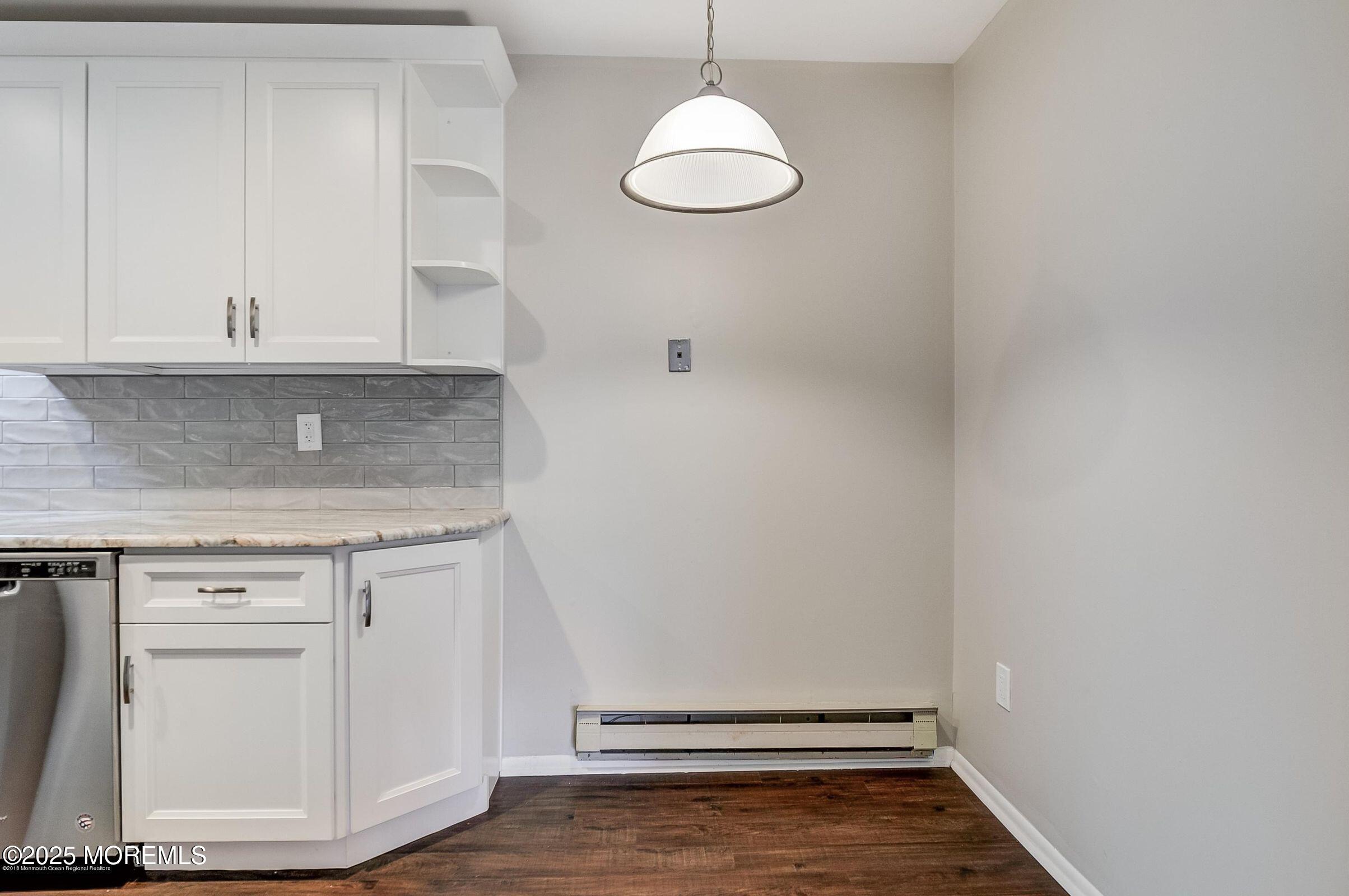 97 Arrowood Road, Unit K Manalapan, NJ 07726 - Photo 5 of 29 an empty room with wooden floor