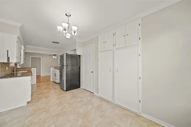a view of a kitchen with refrigerator and cabinet