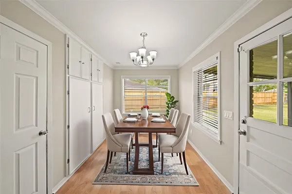a dining room with furniture a rug and a chandelier