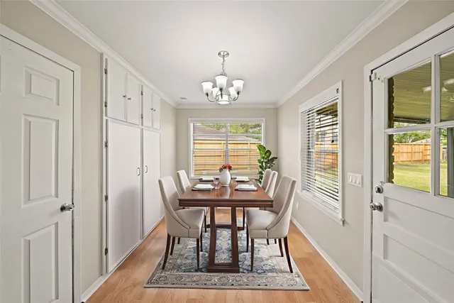 a dining room with furniture a rug and a chandelier