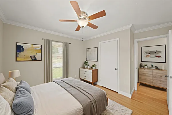 a bedroom with a large bed and a chandelier