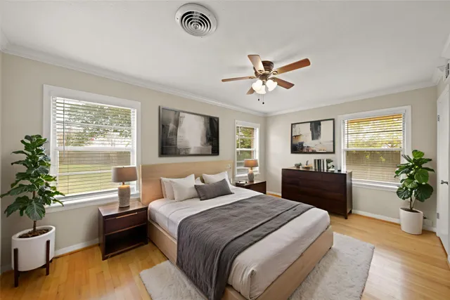 a bedroom with a balcony a bed and a chandelier