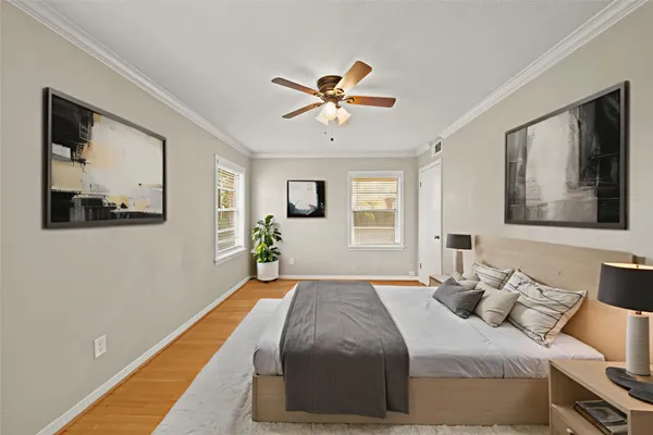 a bedroom with a bed and a painting on the wall