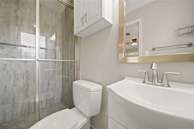 a bathroom with a toilet sink and shower
