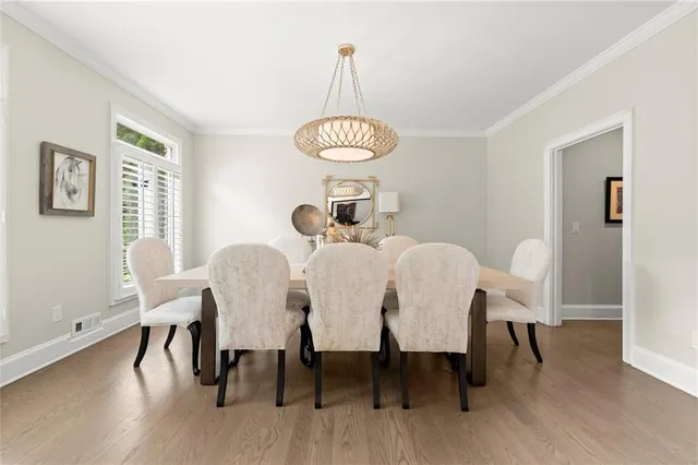 a view of a dining room with a table and chairs