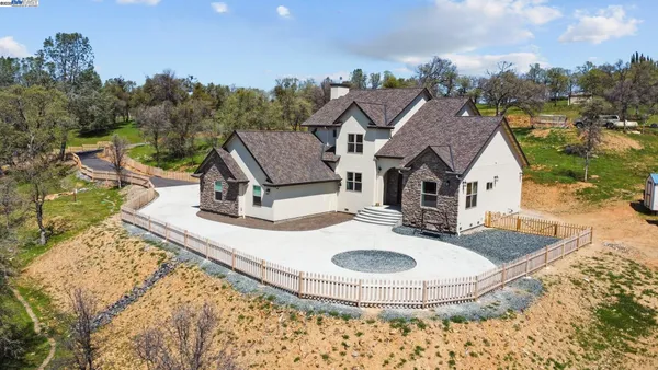 a view of a house with backyard porch and sitting area