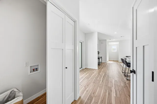a view of a room with wooden floor