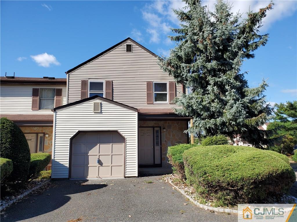 4007 Hana Road Edison, NJ 08817 - Photo 1 of 1 a front view of a house with a garden