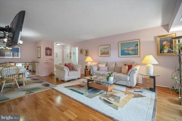 a view of a dining room with furniture and chandelier