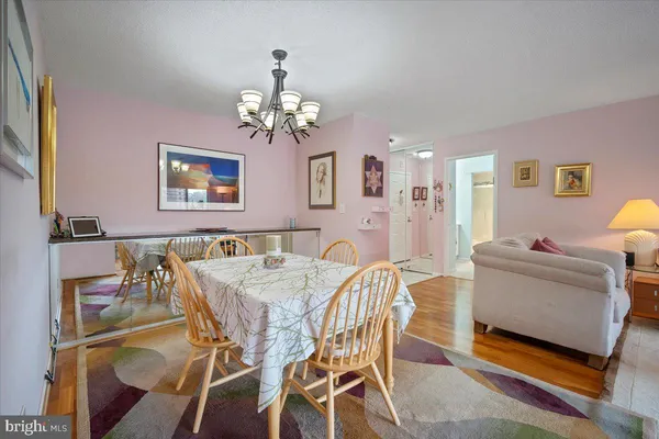 a view of a dining room with furniture and chandelier
