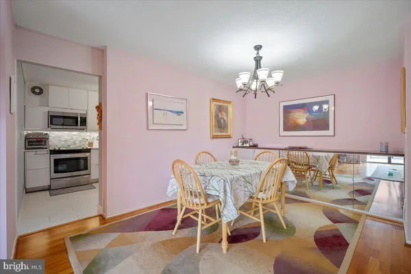 a view of a dining room with furniture and chandelier