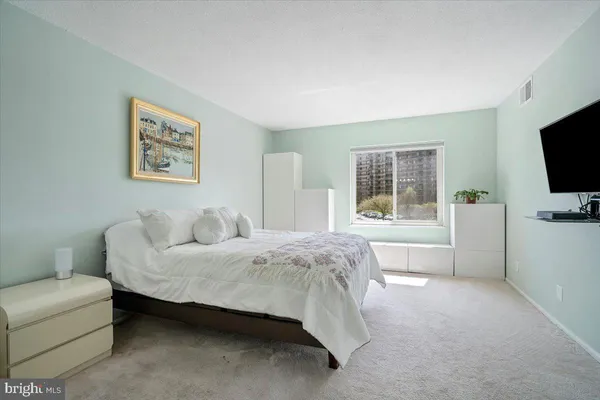 a bathroom with a double vanity sink a mirror and a shower
