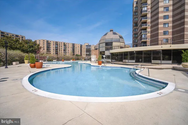 a swimming pool with outdoor seating and yard