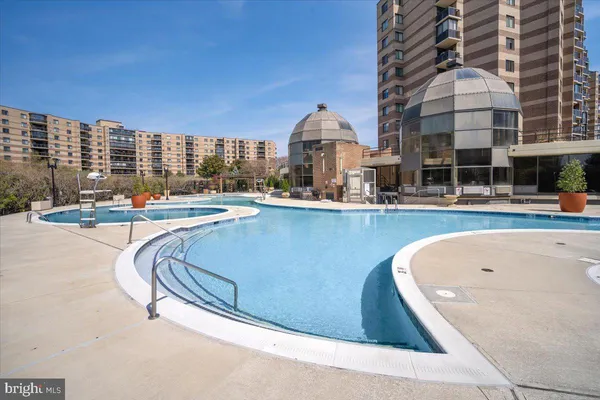 a view of a swimming pool with outdoor seating