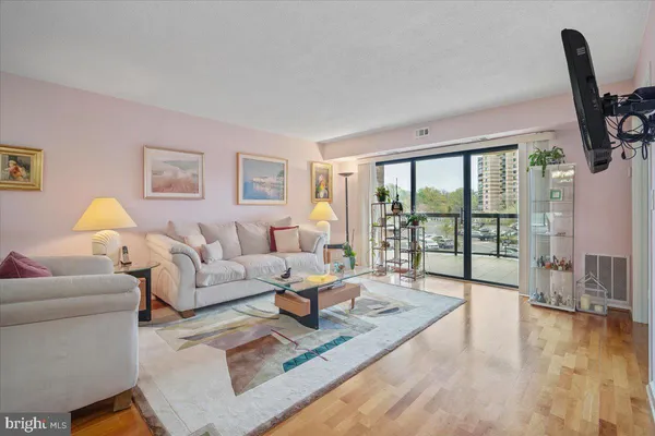 a living room with furniture large windows and a flat screen tv